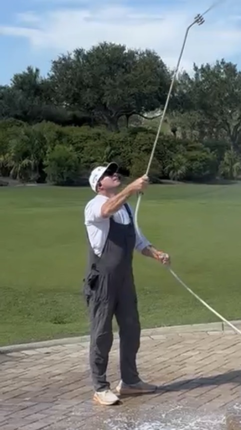 Jordan Hobbs pressure washing at a Naples golf course